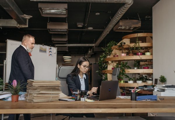 Shadow AI audit team reviewing software use IT colleagues reviewing company software use together during a shadow AI audit in an office